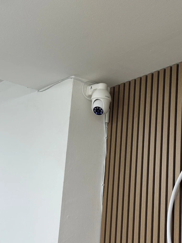 Smart security camera mounted in a corner with tidy cable run