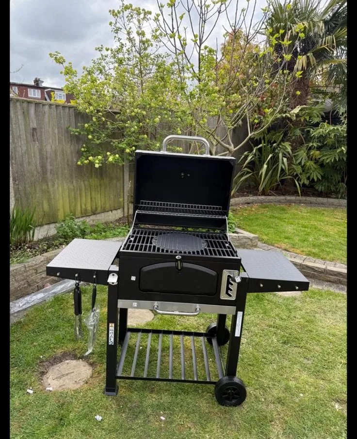 Charcoal BBQ fully assembled in a garden