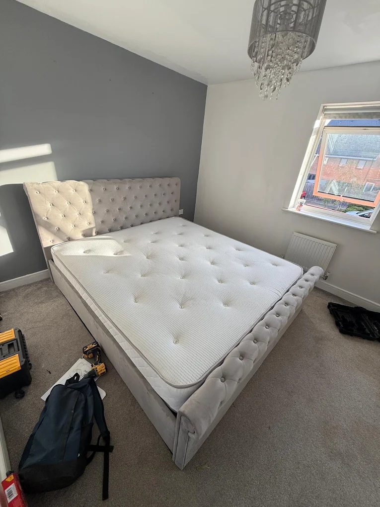 Upholstered king size bed frame assembled in a bedroom